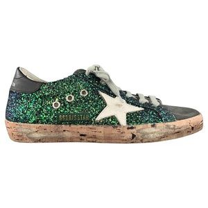 Green glitter golden goose superstar sneakers with cork sole.